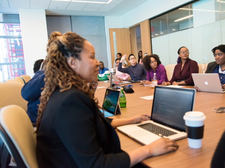 Group of people with laptops at a table