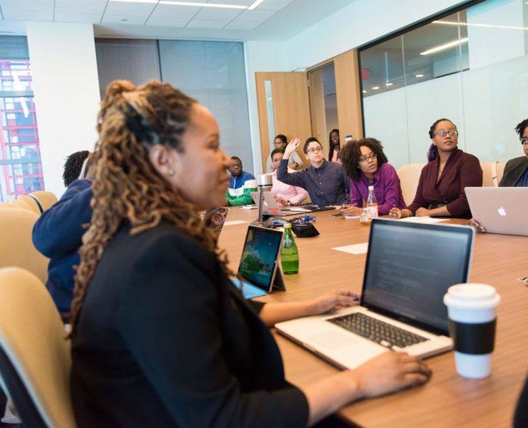 Group of people with laptops at a table